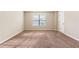 Neutral bedroom featuring carpet floors, a window, and white trim and baseboards at 1646 Sandy Beach Pt, Lawrenceville, GA 30043
