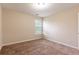 A cozy bedroom featuring plush carpeting and a sunlit window at 1646 Sandy Beach Pt, Lawrenceville, GA 30043