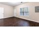 Spacious bonus room with hardwood floors, a large window, and fresh paint, ready for customization at 1646 Sandy Beach Pt, Lawrenceville, GA 30043