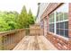 Spacious wooden deck offers views of lush greenery and the exterior brick facade at 1646 Sandy Beach Pt, Lawrenceville, GA 30043