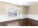 A naturally lit dining room features hardwood floors and classic wainscoting details at 1646 Sandy Beach Pt, Lawrenceville, GA 30043