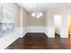 Bright dining room with dark hardwood floors, wainscoting, and modern lighting at 1646 Sandy Beach Pt, Lawrenceville, GA 30043