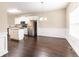 Open-concept dining room with hardwood floors, adjoins kitchen with stainless appliances at 1646 Sandy Beach Pt, Lawrenceville, GA 30043