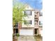 Charming three-story townhouse with a two-car garage and beautifully maintained landscaping at 1646 Sandy Beach Pt, Lawrenceville, GA 30043