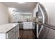 Modern eat-in kitchen with an open concept and stainless steel appliances at 1646 Sandy Beach Pt, Lawrenceville, GA 30043