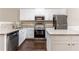 Modern eat-in kitchen boasts white cabinets, granite counters and stainless appliances at 1646 Sandy Beach Pt, Lawrenceville, GA 30043