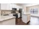 Bright eat-in kitchen features white cabinets, granite counters, stainless appliances and breakfast bar at 1646 Sandy Beach Pt, Lawrenceville, GA 30043