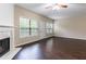 Open concept living room featuring a fireplace, wood floors, and lots of natural light at 1646 Sandy Beach Pt, Lawrenceville, GA 30043