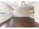 Open-concept living room showcasing hardwood floors, a ceiling fan and lots of natural light at 1646 Sandy Beach Pt, Lawrenceville, GA 30043