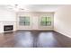 Open concept living room featuring a fireplace, wood floors, and lots of natural light at 1646 Sandy Beach Pt, Lawrenceville, GA 30043