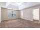 Spacious main bedroom featuring carpet, a trey ceiling with fan, and ensuite bathroom at 1646 Sandy Beach Pt, Lawrenceville, GA 30043