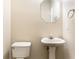 Neutral powder room with pedestal sink, octagon mirror, and towel holder at 1646 Sandy Beach Pt, Lawrenceville, GA 30043