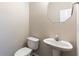 Neutral powder room with a pedestal sink and octagon mirror at 1646 Sandy Beach Pt, Lawrenceville, GA 30043