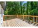 A spacious back deck is surrounded by lush green trees at 2133 Trailwood Rd, Decatur, GA 30032