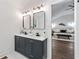 Modern bathroom vanity with double sinks and black hardware, next to a view into the main bedroom at 2133 Trailwood Rd, Decatur, GA 30032