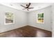 A bright bedroom with hardwood floors, two windows, and a ceiling fan provides plenty of natural light at 2133 Trailwood Rd, Decatur, GA 30032