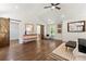 Spacious bedroom with hardwood floors, modern dresser, barn door to the walk-in closet, and a comfortable seating area at 2133 Trailwood Rd, Decatur, GA 30032