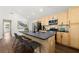 Kitchen featuring a large island with barstool seating, stainless steel appliances, and light wood cabinets at 2133 Trailwood Rd, Decatur, GA 30032