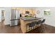 Kitchen with a center island, stainless steel appliances, black countertops, and light wood cabinets at 2133 Trailwood Rd, Decatur, GA 30032