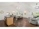 A spacious living room and dining area, accentuated by hardwood floors, modern lighting, and natural light from ample windows at 2133 Trailwood Rd, Decatur, GA 30032