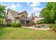 Beautiful backyard with pool, seating area, umbrella, landscaping, and a view of the home at 2700 Vinings Orchard Cir, Atlanta, GA 30339