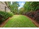 A well-manicured backyard is lined with lush greenery providing a private outdoor space at 2700 Vinings Orchard Cir, Atlanta, GA 30339