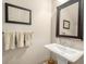 Traditional powder room featuring a pedestal sink, decorative mirror, and neutral finishes at 2700 Vinings Orchard Cir, Atlanta, GA 30339