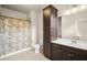 Bathroom with a shower/tub, toilet, vanity with sink, mirror, and a tall cabinet at 2700 Vinings Orchard Cir, Atlanta, GA 30339