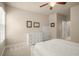 Bedroom with ceiling fan, carpet flooring, and white dresser next to view of the hallway and rooms at 2700 Vinings Orchard Cir, Atlanta, GA 30339