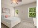 Cozy bedroom with white furniture, two windows and a ceiling fan with neutral carpet flooring at 2700 Vinings Orchard Cir, Atlanta, GA 30339