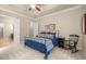 Comfortable bedroom featuring a cozy bed with blue accents, rocking chair, and neutral carpeting at 2700 Vinings Orchard Cir, Atlanta, GA 30339
