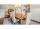 Formal dining room with hardwood floors, wainscoting, a wooden table with seating for six, and an elegant chandelier at 2700 Vinings Orchard Cir, Atlanta, GA 30339