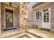 Inviting front entrance with a stone-accented column, decorative wreath, and a well-maintained brick facade at 2700 Vinings Orchard Cir, Atlanta, GA 30339