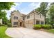 The traditional two-story home features a stone and siding facade, a two-car garage, and manicured landscaping at 2700 Vinings Orchard Cir, Atlanta, GA 30339