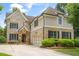 Charming two-story brick home with manicured landscaping, a two-car garage, and a welcoming stone-accented entrance at 2700 Vinings Orchard Cir, Atlanta, GA 30339