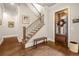 Entryway with hardwood floors, staircase, and a glass-paneled front door creating a warm and welcoming atmosphere at 2700 Vinings Orchard Cir, Atlanta, GA 30339