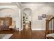 Hallway with hardwood floors, neutral walls, and an arched entryway leading to an open-concept living space at 2700 Vinings Orchard Cir, Atlanta, GA 30339