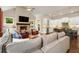 Open-concept living room with a fireplace, vaulted ceiling, and an adjacent kitchen with a breakfast bar at 2700 Vinings Orchard Cir, Atlanta, GA 30339