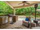 Covered patio with outdoor kitchen, seating, and a view of the pool at 2700 Vinings Orchard Cir, Atlanta, GA 30339