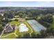 Scenic aerial view of the community clubhouse, pool, and tennis courts surrounded by lush greenery at 2740 Heritage Bend Sw Ct, Grayson, GA 30017