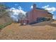 Brick home with large backyard, mature trees, and a deck providing ample outdoor space at 2740 Heritage Bend Sw Ct, Grayson, GA 30017