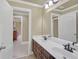 A spacious bathroom with double sink vanity, large mirror, and open doorway at 2740 Heritage Bend Sw Ct, Grayson, GA 30017