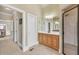 Bathroom view showcasing a wood vanity with white countertops and a glass-enclosed shower at 2740 Heritage Bend Sw Ct, Grayson, GA 30017
