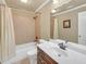 Bright bathroom with a combination bathtub and shower with tile surround and single sink vanity at 2740 Heritage Bend Sw Ct, Grayson, GA 30017