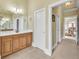 Bright bathroom featuring a wood vanity with white countertops and tile flooring at 2740 Heritage Bend Sw Ct, Grayson, GA 30017