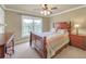 Cozy bedroom featuring a wooden bed frame, bedside table, and window with natural light at 2740 Heritage Bend Sw Ct, Grayson, GA 30017