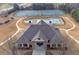 Aerial view of community center, tennis courts, and pool in a well-maintained neighborhood at 2740 Heritage Bend Sw Ct, Grayson, GA 30017