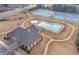 Overhead view of the community clubhouse, pool, and tennis courts in a picturesque setting at 2740 Heritage Bend Sw Ct, Grayson, GA 30017