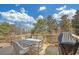 Outdoor deck with dining table and chairs set with trees in the background at 2740 Heritage Bend Sw Ct, Grayson, GA 30017
