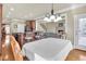 An open dining area shows wood floors, and views into the kitchen, living area, and staircase at 2740 Heritage Bend Sw Ct, Grayson, GA 30017